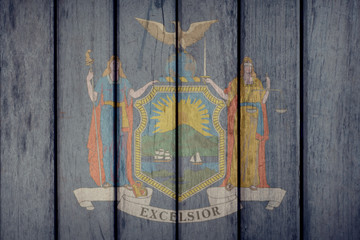 USA Politics News Concept: US State New York Flag Wooden Fence