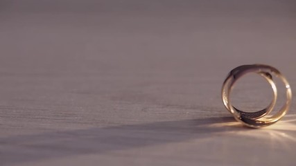 Two wedding rings rolling on the floor