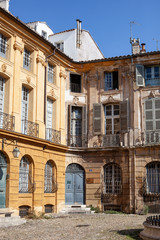 Fototapeta na wymiar Beautiful weathered apartment buildings in the charming city of Aix-en-Provence