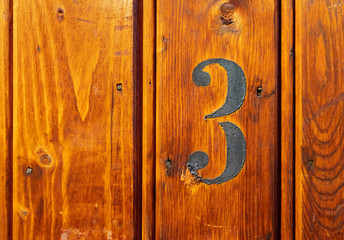 number 3 on door of storage room for tenants in century-old apartment building in stockholm
