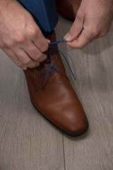 Grooms morning preperation closeup, brown leather shoes