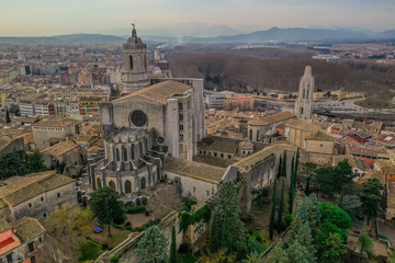 Obraz premium Aerial panorama view of medieval Girona with Gothic St Mary Roman Catholic cathedral, city walls and colorful houses at sunset in Girona Catalonia Spain