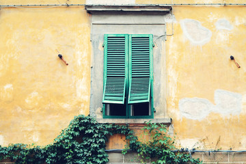 Old window with wooden green shutters, Lucca, Italy