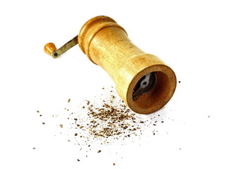 Pepper mill on a white isolated background with peppers