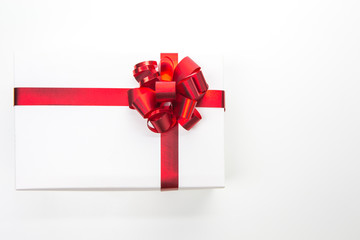 One White Christmas Gift Box Wrapped in Red Ribbon Placed on white Background