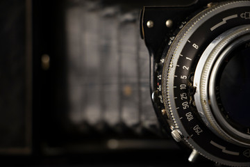 Bellows analogue camera on the black background and it like vintage or retro concept.