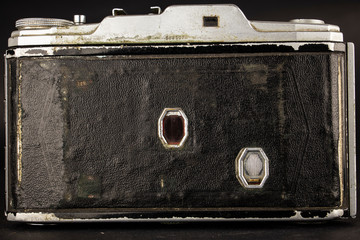 Bellows analogue camera on the black background and it like vintage or retro concept.