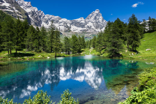 Summer alpine landscape with the Matterhorn (Cervino) reflected on the Blue Lake (Lago Blu) near Breuil-Cervinia, Aosta Valley, northern Italy