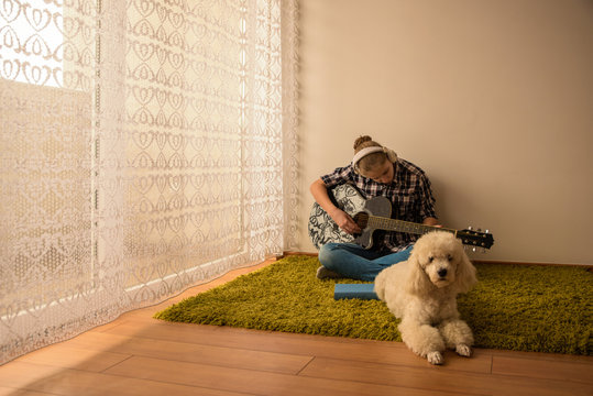 Teenager  plays guitar