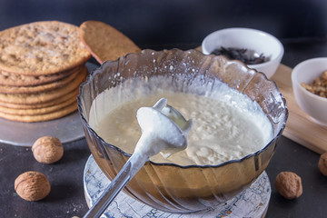 Whipping cream and eggs for homemade cake with electric whisk
