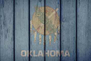 USA Politics News Concept: US State Oklahoma Flag Wooden Fence
