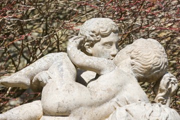 An outdoors, stone statue of two boys kissing. It could be platonic, but it could also be gay - one boy has his hand on the other's buttock, which isn't very platonic
