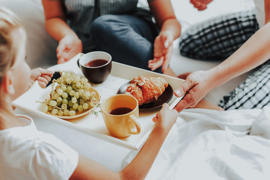 Happy Child Bringing Breakfast To Parents In Bed