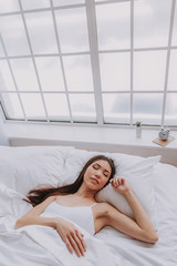 Calm asian woman sleeping in cozy apartment