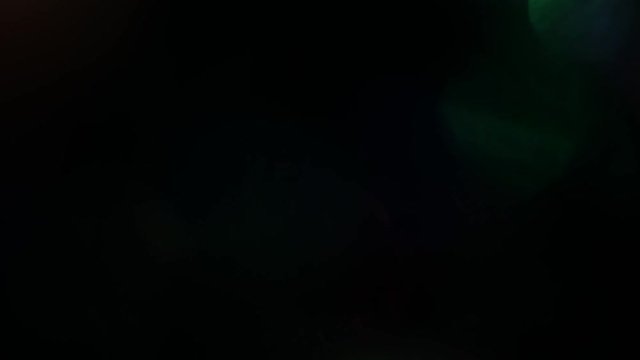 Soft and gentle multicolored particles gently flickering in the dark.