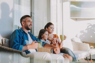 Pleasant smiling family resting at home together