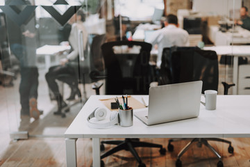 Horizontal photo of workplace in modern office