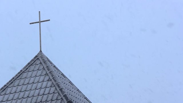 Winter Background Church Cross Snow Fall. Slowly Falling Snow Flakes Against White Sky.	