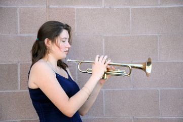 Female beauty blowing her trumpet outside.