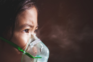 Asian child girl has asthma or pneumonia disease and need nebulization by get inhaler mask on her...