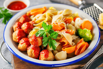Meatballs with Conchiglie, broccoli and a cauliflower in a plate on a table. Diet food.