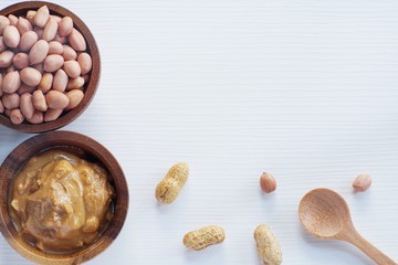 Peanut in wooden bowl on classic wooden table background, peanut butter