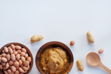 Peanut in wooden bowl on classic wooden table background, peanut butter