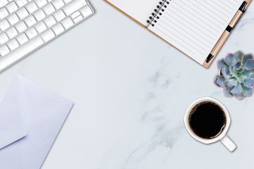 Office table with notepad and computer keyboard and other office supplies. Top view with copy space, flat lay.