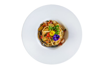 Stir-fried spicy spaghetti with seafoods on white background.