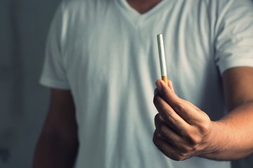 Close up male hand holding a cigarette