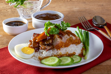 Red pork rice on a wood background