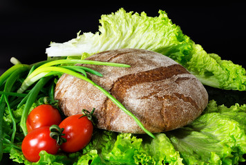 healthy breakfast of bread and vegetables. Bread, tomatoes, vegetables on a dark background.