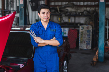 Hand of car mechanic with wrench. at car repair garage at excellent