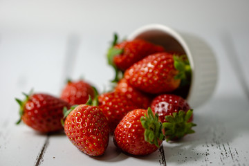 Strawberry in a bowl isolated on white background. Selective focus.