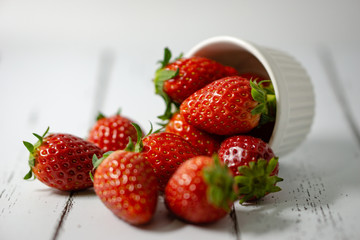Strawberry in a bowl isolated on white background. Selective focus.