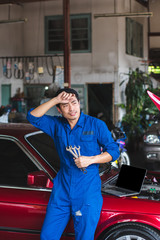 Hand of car mechanic with wrench. at car repair garage Have fatigue