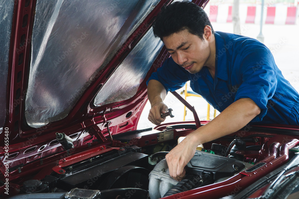 Wall mural car mechanic, hold wrench working in garage. repair service. - image