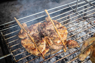 Thai whole chicken grilled with charcoal on street.