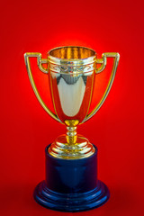 Miniature trophy on a red background