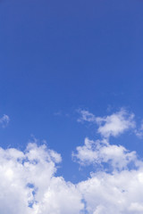 Blue sky background with white clouds, rain clouds on sunny summer or spring day.