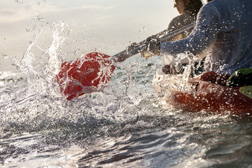 Closeup photo of splashes from kayak or canoe paddle at sea bay. Kayaking or canoeing concept - obrazy, fototapety, plakaty
