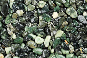 Extreme close up of dark green coloured natural stone carpet. Different shades and tints of green....