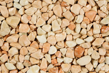 Extreme close up natural stone carpet, beige and cream coloured in different shades and tints of beige. Decorative stone coating. Slip resistant floor finish containing natural stone particles.