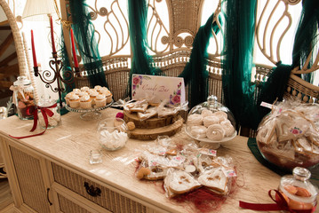 Candy bar. White wedding cake standing of festive table with deserts, tartlet and cupcakes. Wedding.