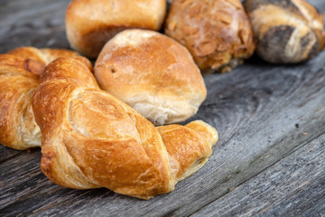 different fresh rolls and croissants in top view