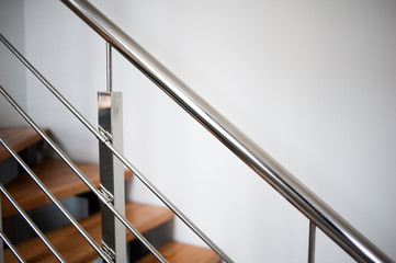 Modern wooden stairs and metal railings
