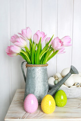 Bouquet of pink tulips in silver watering can.