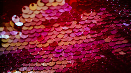 Glittering fabric design. Red gradient sequin background.