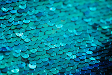 Glittering textile design. Blue sequin background. Mermaid scale concept.