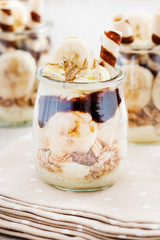 Layer dessert with muesli, chocolate and banana fruits.